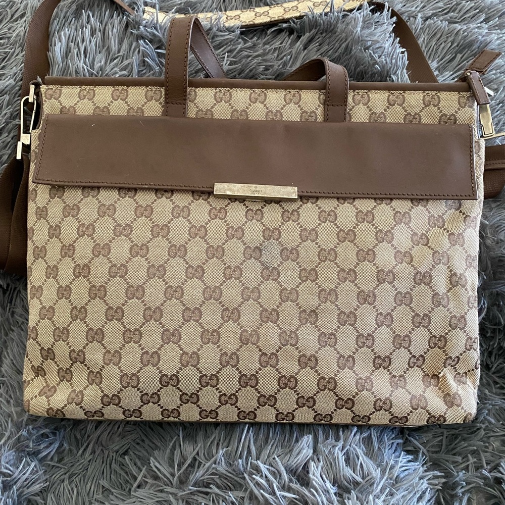 Gucci briefcase. Gucci’s iconic GG canvas with leather trim. Made in Italy.